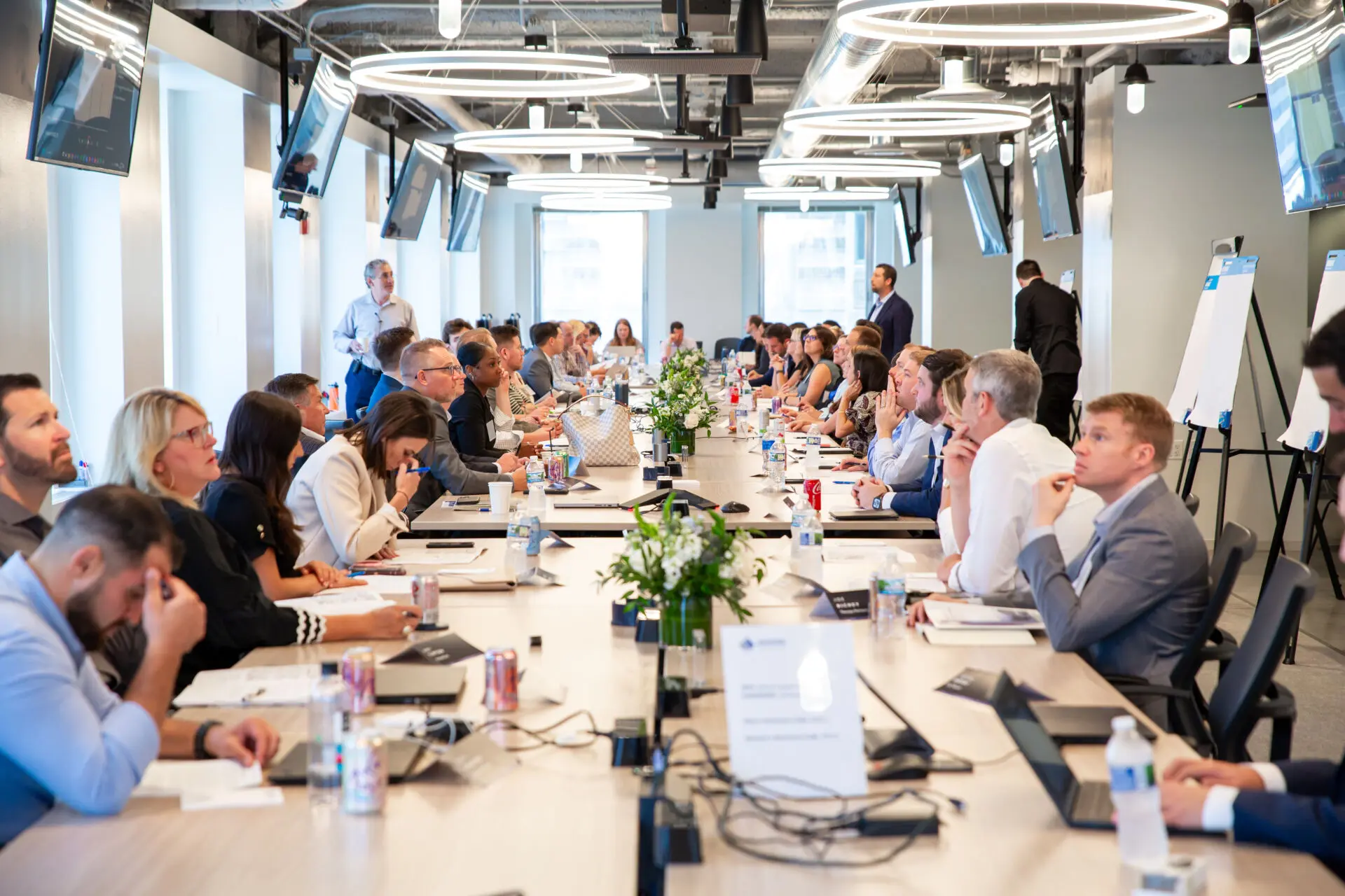 Long table of executives attend a meeting at Shore Capital Partners Office