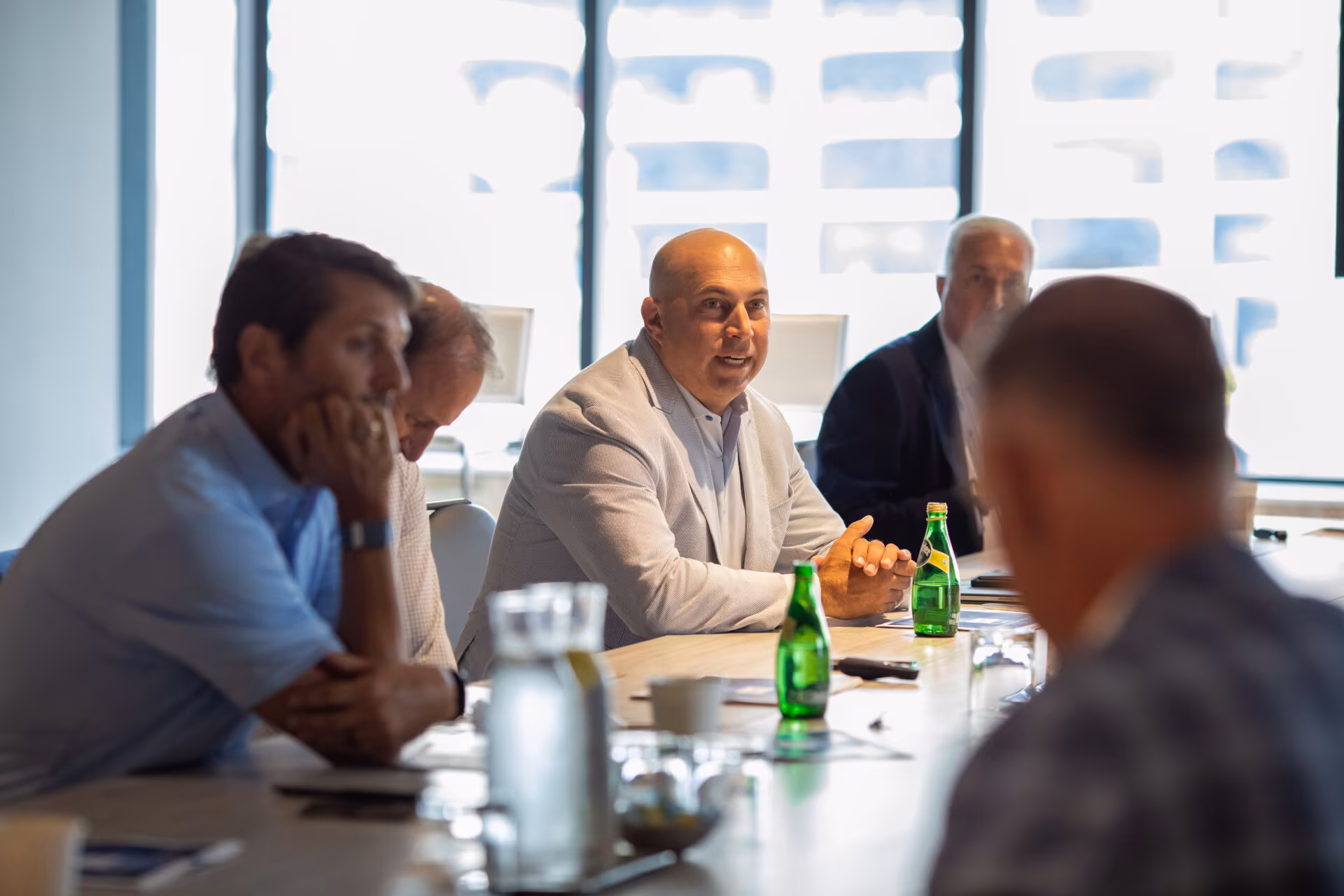 Executives seated at a conference room table